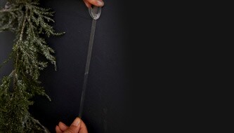 Person removing a Command™ hook from wall
