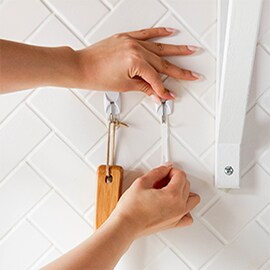Person showing how to remove Command™ Hooks safely and correctly