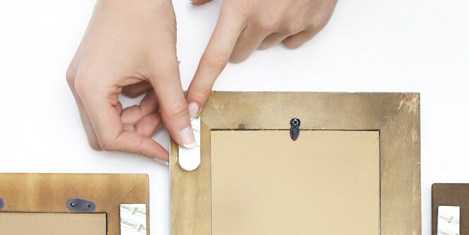 Applying Command picture hanging strips to picture frame
