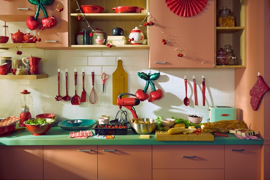 Tidy entryway with Command hooks holding a dog leash, brush, and collar. Below are pet bowls, a storage bin, and a toy basket. A cushioned bench sits above the storage area.
