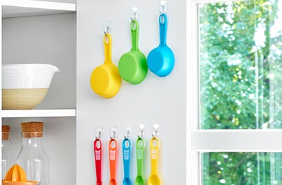 Organising inside kitchen wall cupboard with Command™ solutions
